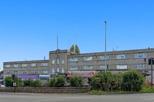 a large brick building on the side of a street at West Five, Double Bedroom Suite with Private Bathroom in London