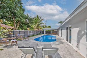 a patio with a swimming pool and chairs at Spacious 4 bedrooms, 2 bathroom house with pool in Miramar