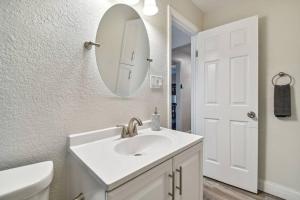 a white bathroom with a sink and a mirror at Chic & Cozy 3 Bed/2 Bath House Near Beaches in Largo