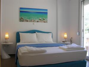 a bedroom with a bed with two towels on it at Mediterraneo Resort in Parga