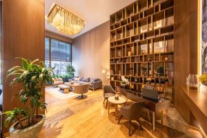 a living room with a couch and a table and chairs at Radisson Residences Vadistanbul in Istanbul