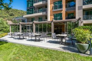 a patio with tables and chairs in front of a building at Radisson Residences Vadistanbul in Istanbul
