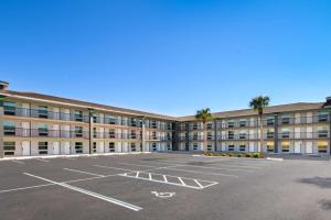 an empty parking lot in front of a building at SureStay Hotel by Best Western Clermont Theme Park West in Kissimmee