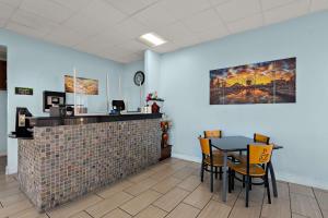 a dining room with a table and chairs at SureStay Hotel by Best Western Clermont Theme Park West in Kissimmee