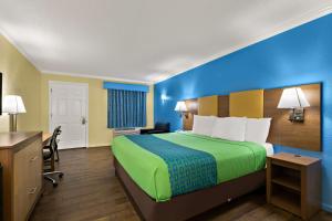 a hotel room with a bed and a desk at SureStay Hotel by Best Western Clermont Theme Park West in Kissimmee