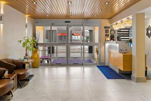a lobby with the doors open to a lobby with purple mats at SureStay Plus by Best Western Brooks in Brooks