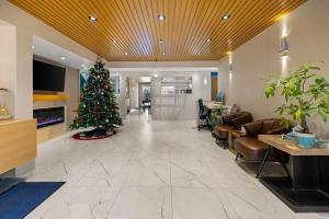 a christmas tree in the middle of a lobby at SureStay Plus by Best Western Brooks in Brooks