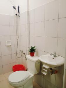 a bathroom with a toilet and a sink at Mariana Condotel in Puerto Princesa City