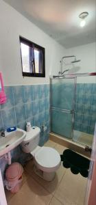 a bathroom with a toilet and a sink and a shower at Villa KIKI Ensenada in Punta Rucia +51 photos
