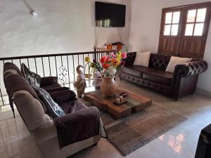 a living room with two couches and a coffee table at Villa del Socorro in Jardin