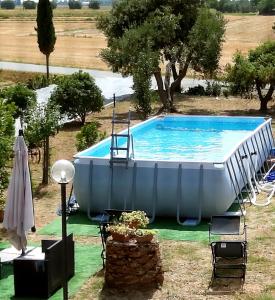 a large swimming pool in the middle of a yard at Agriturismo Stella Marina in Piombino