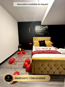 a bedroom with a bed with red balloons on the floor at 4 Bedroom House, Heathrow Airport, Luxe Inn in Colnbrook
