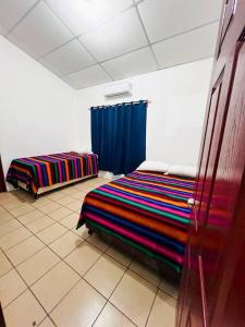 a bedroom with two beds in a room at Casa de playa “mi lancho” in La Libertad