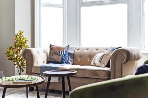 a living room with a couch and two tables at Stylish Sanctuary in London in London