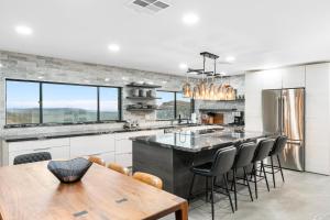 a kitchen with a wooden table and chairs and a counter at Seven Canyons Sedona Luxury with Panoramic Views in Sedona