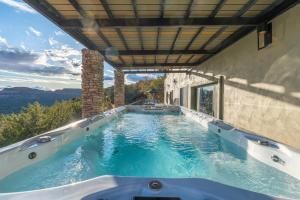 a swimming pool in the middle of a house at Seven Canyons Sedona Luxury with Panoramic Views in Sedona