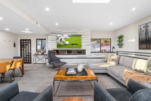 a living room with a couch and a tv at Seven Canyons Sedona Luxury with Panoramic Views in Sedona