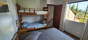 En eller flere senge i et værelse på Apartamento aconchegante e confortável