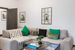 a living room with a couch and a table at Trendy 3-Bedroom Hackney Pad in London