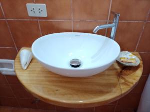 a white sink on top of a wooden cutting board at Arica Surf & Beach House in Arica +36 photos