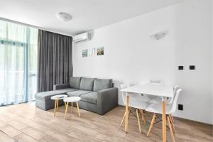 a living room with a couch and a table at Paradise Apartments Primorsko in Primorsko