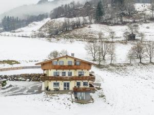 a house in the snow with snow covered ground at Sunnseitn in Goldegg