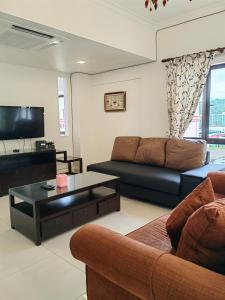a living room with a couch and a coffee table at Town Condo - Marina Court Kota Kinabalu in Kota Kinabalu