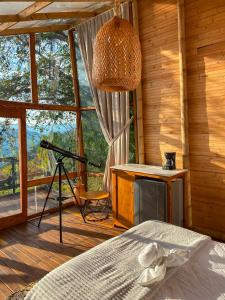 a bedroom with a bed and a table and a desk at NaturalMente Glamping in San Antonio del Tequendama