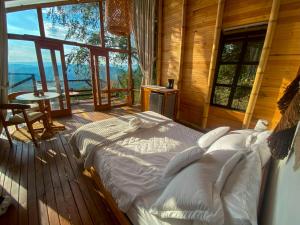a bedroom with a large bed in a wooden cabin at NaturalMente Glamping in San Antonio del Tequendama