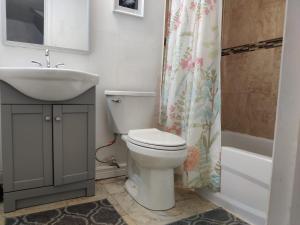 a bathroom with a toilet and a sink at Spacious MBR Near Kennedy Subway & GO in Toronto