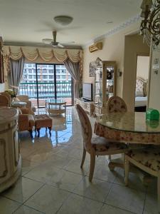 a large living room with a table and chairs at Town Condo - Marina Court Kota Kinabalu in Kota Kinabalu