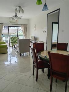 a living room with a dining room table and chairs at Town Condo - Marina Court Kota Kinabalu in Kota Kinabalu