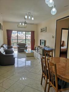 a living room with a table and a couch at Town Condo - Marina Court Kota Kinabalu in Kota Kinabalu