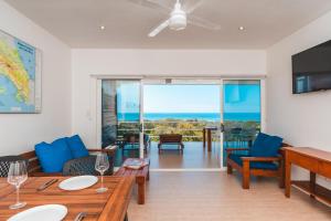 a living room with a couch and a table at Buena Vista Ocean View Apartments Santa Teresa in Santa Teresa Beach