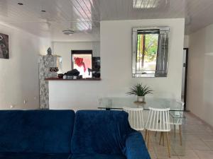 a living room with a blue couch and a glass table at SIMPLISSIME T4 à KOUROU in Kourou