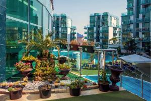 a balcony with potted plants on a building at Paradise Apartments Primorsko in Primorsko