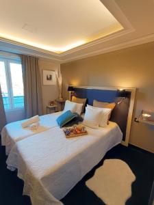a hotel room with a large bed with a tray on it at Studio haut de gamme sur golf proche Montpellier in Montpellier