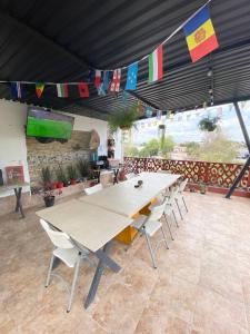 a large table and chairs in a room with flags at Hostal Talavera in Puebla