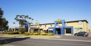 a building with a car parked in front of a street at Nightcap at St Albans Hotel in St Albans