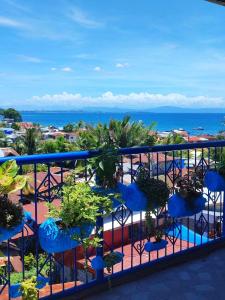 a balcony with chairs and plants and the ocean at 2 BD, 2BR Condo Rental,Toril in Davao City