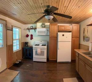 cocina con electrodomésticos blancos y ventilador de techo en Quiet Retreat in Amish country, 