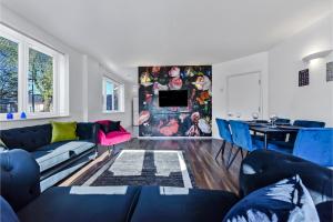 a living room with a couch and a table at Charming and Modern 2 BR Flat in London