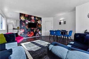 a living room with blue couches and a dining room at Charming and Modern 2 BR Flat in London