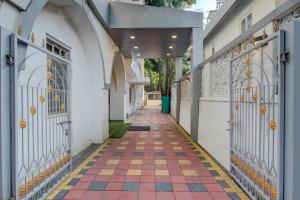 an alley with gates and a tiled floor at Super Collection O Sunshine Near Inox in Pune +47 photos