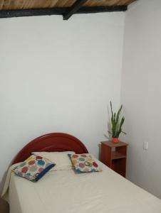 a bedroom with a bed with two pillows on it at Casa Betania, entorno natural in Páramo