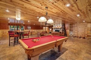 a living room with a pool table in it at Woodhaven On Leech Lake in Cass Lake