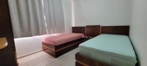 a bedroom with two beds and a window at PRIVÉ DAS THERMAS I apto 1001C in Caldas Novas +72 photos