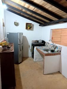 cocina con fregadero y nevera en Casa Betania, entorno natural, en Páramo