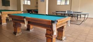 a pool table in a room with two tables at PRIVÉ DAS THERMAS I apto 1001C in Caldas Novas