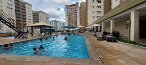 a group of people in a swimming pool at Residencial Privé das Thermas I in Caldas Novas